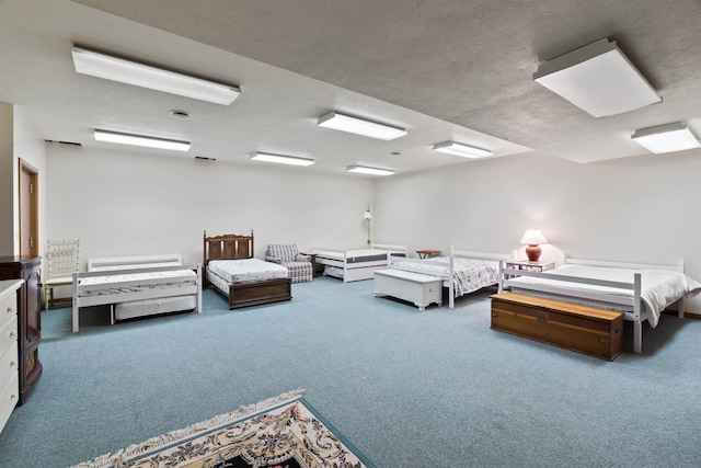 bedroom featuring carpet floors and a textured ceiling