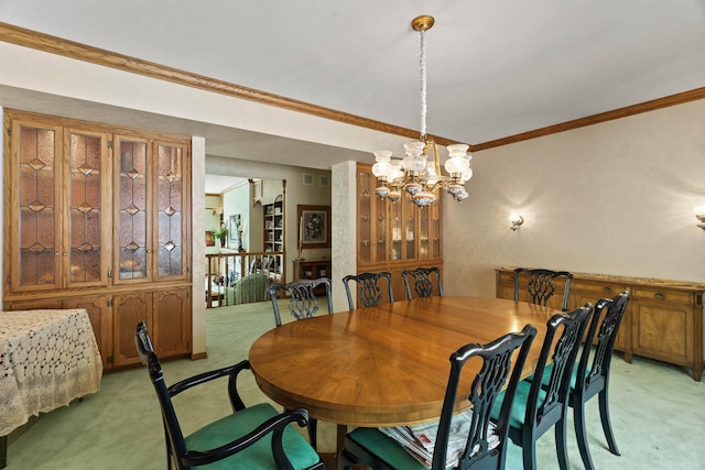 carpeted dining room featuring crown molding and a chandelier