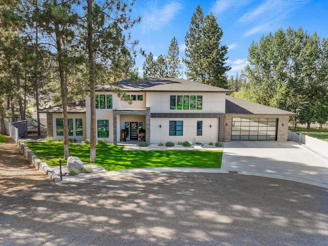 view of front of property featuring a lawn and a garage