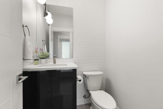 bathroom featuring vanity and toilet