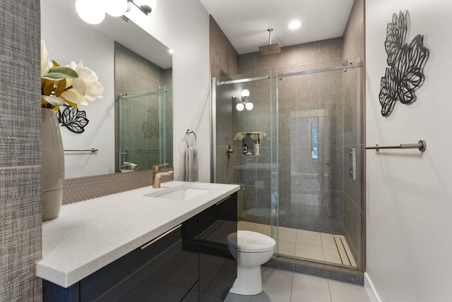 bathroom featuring toilet, vanity, tile patterned floors, and walk in shower