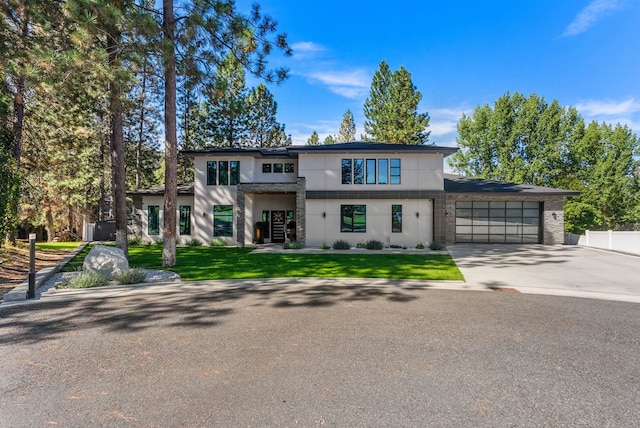 view of front of house featuring a garage and a front lawn