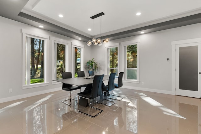 tiled dining area featuring a raised ceiling, plenty of natural light, and a notable chandelier