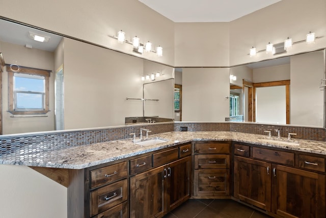 bathroom featuring tile patterned flooring, vanity, and tasteful backsplash