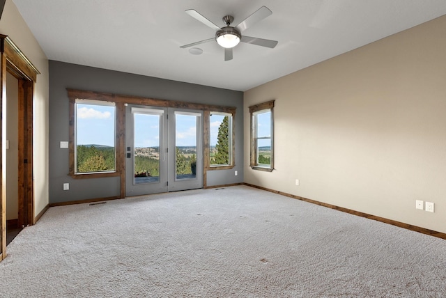 unfurnished room with light carpet, ceiling fan, and plenty of natural light