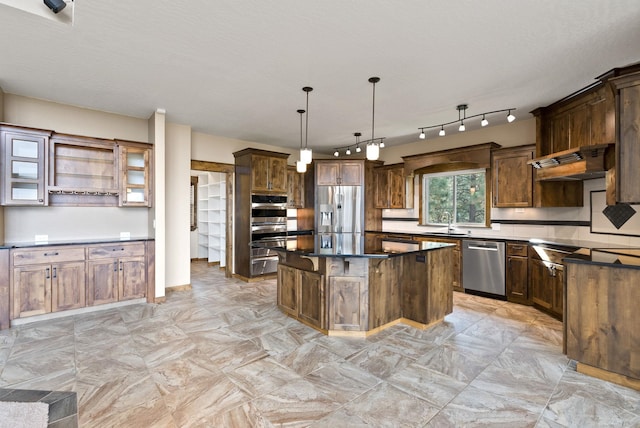 kitchen with a sink, stainless steel appliances, a kitchen island, premium range hood, and dark countertops