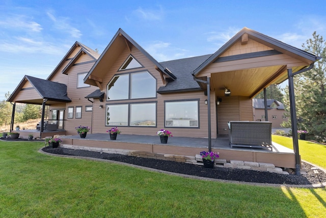 back of house with a lawn and a patio
