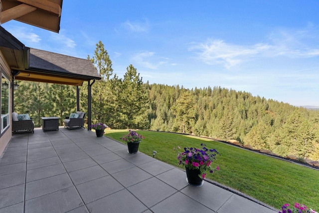view of patio / terrace with a wooded view