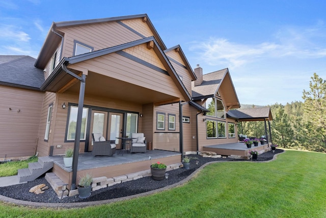 rear view of property with a lawn and a patio area