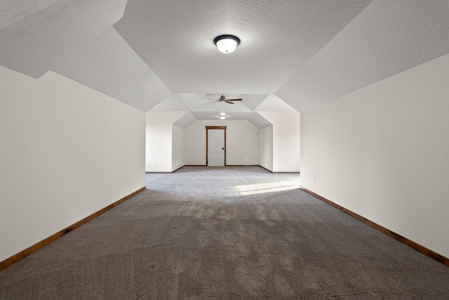 additional living space with a ceiling fan, carpet flooring, vaulted ceiling, and baseboards