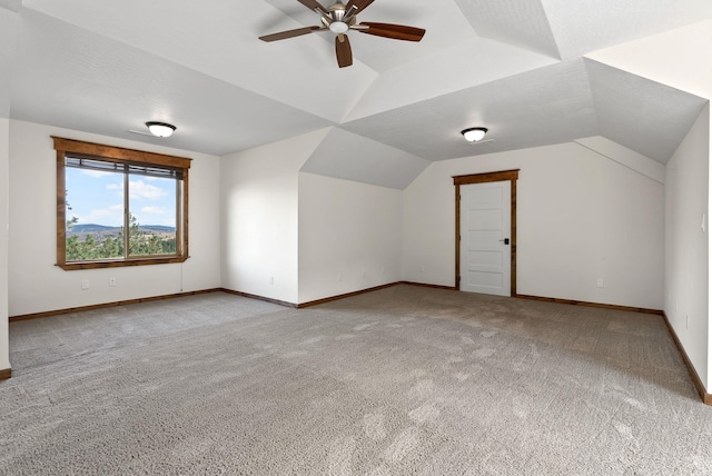 bonus room featuring baseboards, a ceiling fan, carpet floors, and lofted ceiling