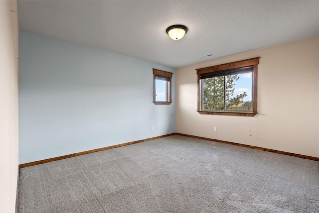 carpeted empty room with baseboards