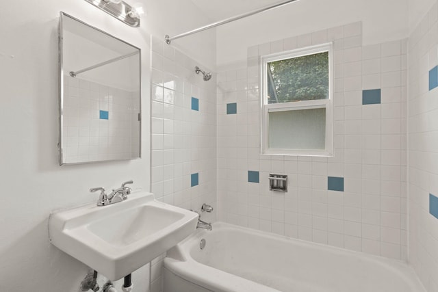 bathroom featuring tiled shower / bath combo and sink