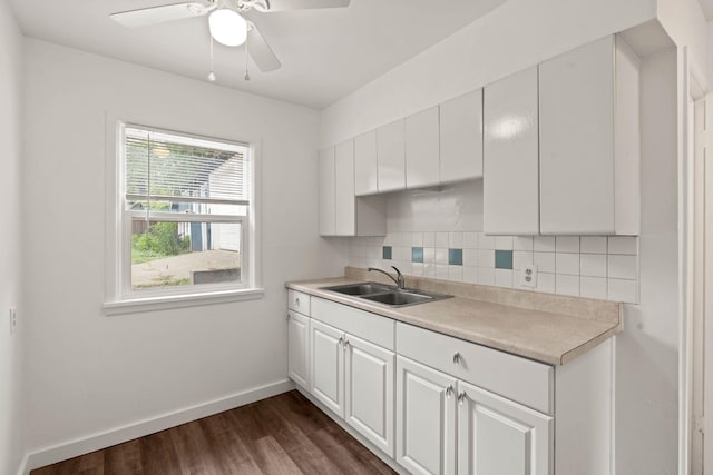 kitchen featuring dark hardwood / wood-style floors, sink, white cabinetry, backsplash, and ceiling fan