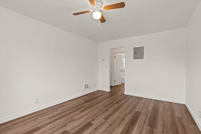 unfurnished room featuring dark hardwood / wood-style flooring, ceiling fan, and electric panel