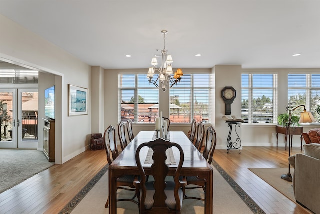 dining room featuring light wood-type flooring and a notable chandelier