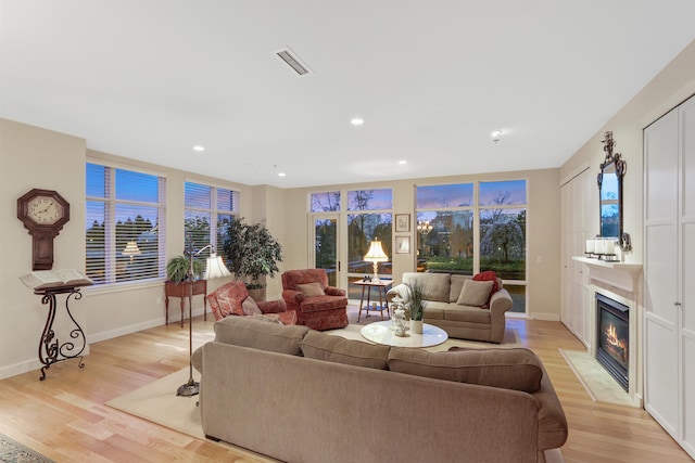 820 N Post St Unit 106, Spokane, WA 99201 - living area with recessed lighting, baseboards, a fireplace with flush hearth, and light wood finished floors