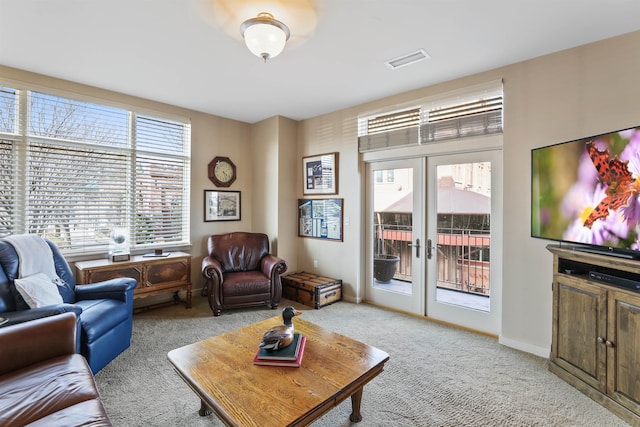 living room featuring french doors and light colored carpet