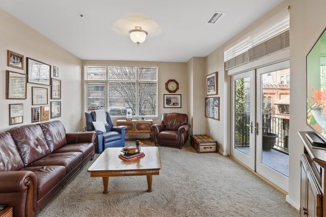 living room with french doors and light colored carpet