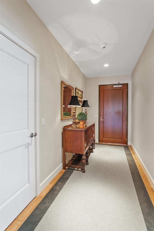 corridor with dark hardwood / wood-style floors