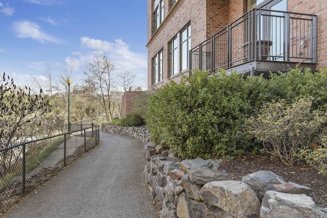 820 N Post St Unit 106, Spokane, WA 99201 - view of property exterior with a balcony, fence, and brick siding