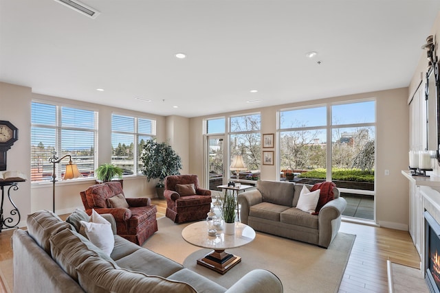 820 N Post St Unit 106, Spokane, WA 99201 - living room with light wood finished floors, recessed lighting, baseboards, a fireplace with flush hearth, and visible vents