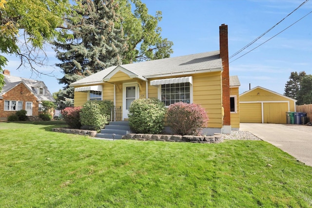 view of front of home featuring an outbuilding, a garage, and a front yard