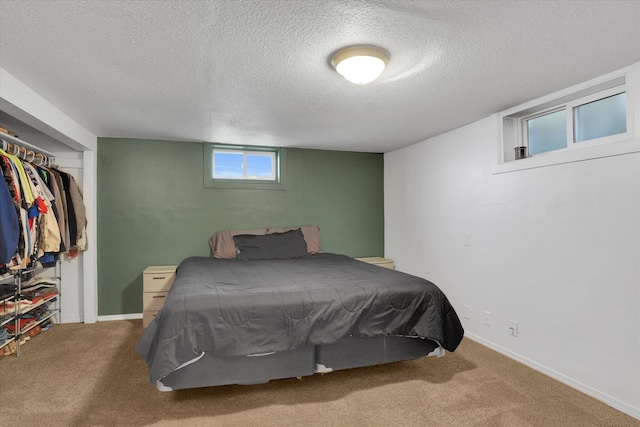 bedroom with carpet floors, a textured ceiling, and a closet