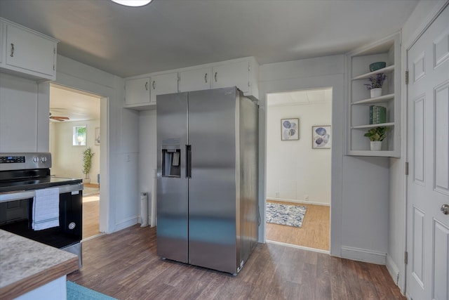 kitchen with white cabinets, stainless steel appliances, and dark hardwood / wood-style floors