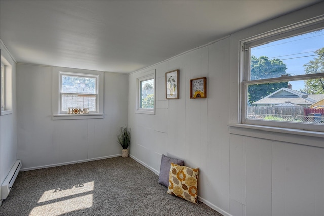 carpeted spare room featuring baseboard heating