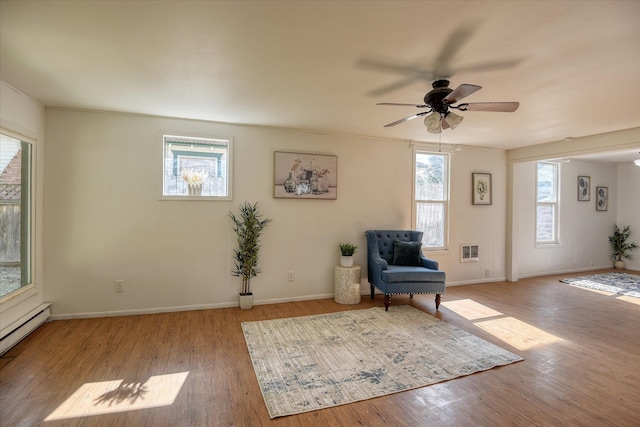 unfurnished room with ceiling fan, light hardwood / wood-style flooring, and baseboard heating