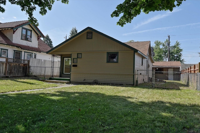 back of property with a lawn