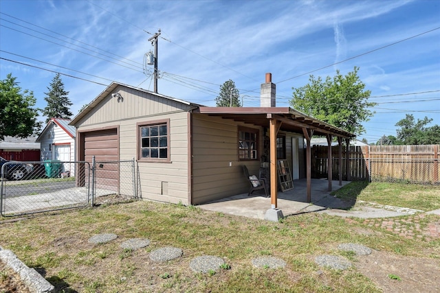 view of outdoor structure with a lawn and a garage