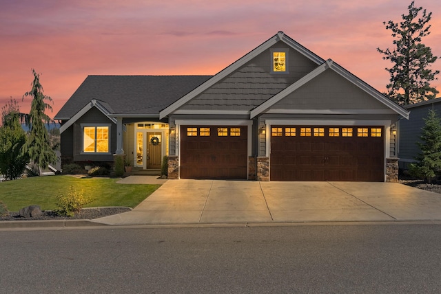 craftsman-style house with a yard and a garage