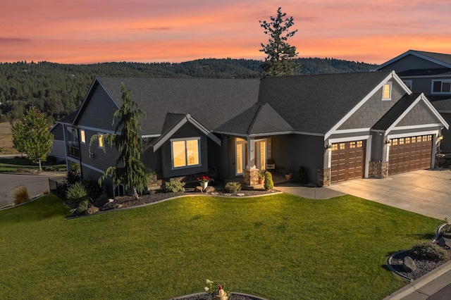 view of front of home featuring a garage and a lawn