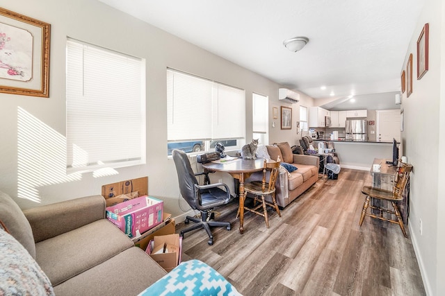 2213 E E Gordon Ave, Spokane, WA 99207 - living room with a wall mounted air conditioner, wood finished floors, and baseboards