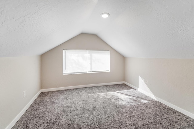 2213 E E Gordon Ave, Spokane, WA 99207 - additional living space with a textured ceiling, carpet, lofted ceiling, and baseboards