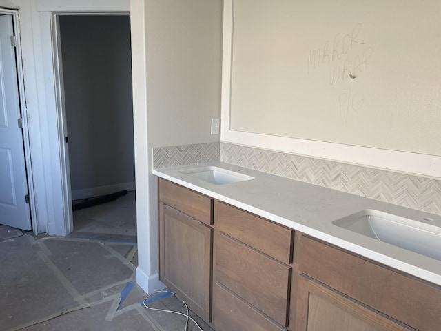 bathroom with decorative backsplash and vanity