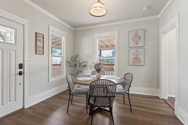 dining space with crown molding and dark hardwood / wood-style flooring