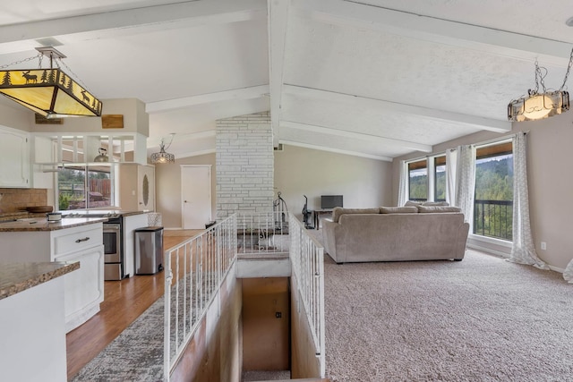 living room with vaulted ceiling with beams and hardwood / wood-style floors