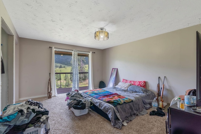 carpeted bedroom featuring a textured ceiling