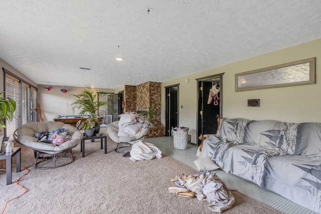 living room featuring a textured ceiling and light colored carpet