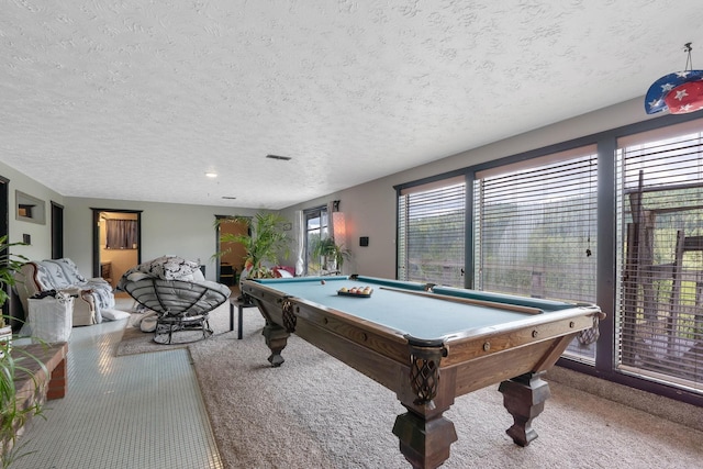 playroom with a textured ceiling, billiards, carpet flooring, and a wealth of natural light