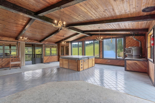 unfurnished sunroom featuring vaulted ceiling with beams, a wood stove, a chandelier, and wood ceiling