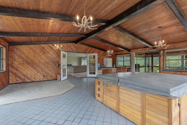 kitchen featuring a notable chandelier, wooden walls, vaulted ceiling with beams, and wooden ceiling