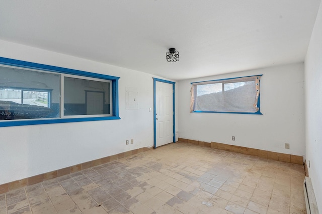 unfurnished room with a baseboard radiator