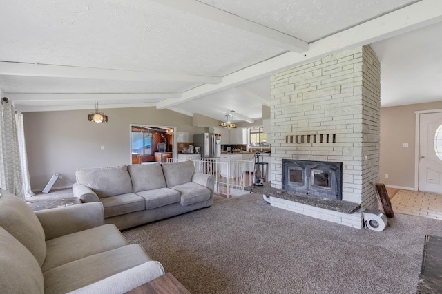 carpeted living room featuring vaulted ceiling with beams, a stone fireplace, a textured ceiling, and a chandelier