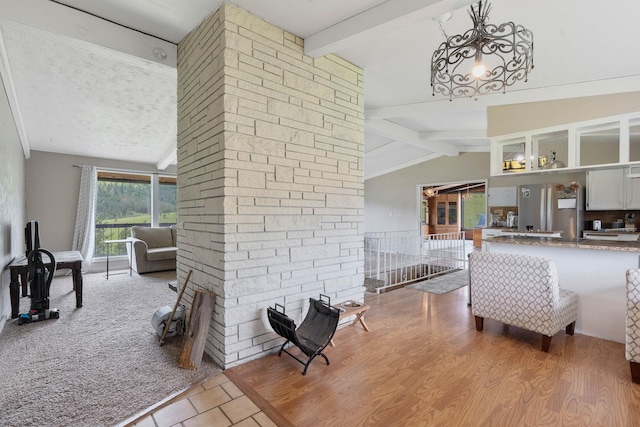 living room with lofted ceiling with beams and light hardwood / wood-style floors