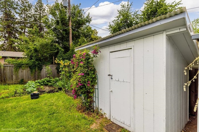 view of outbuilding with a yard