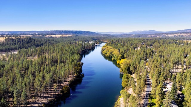 birds eye view of property with a water and mountain view